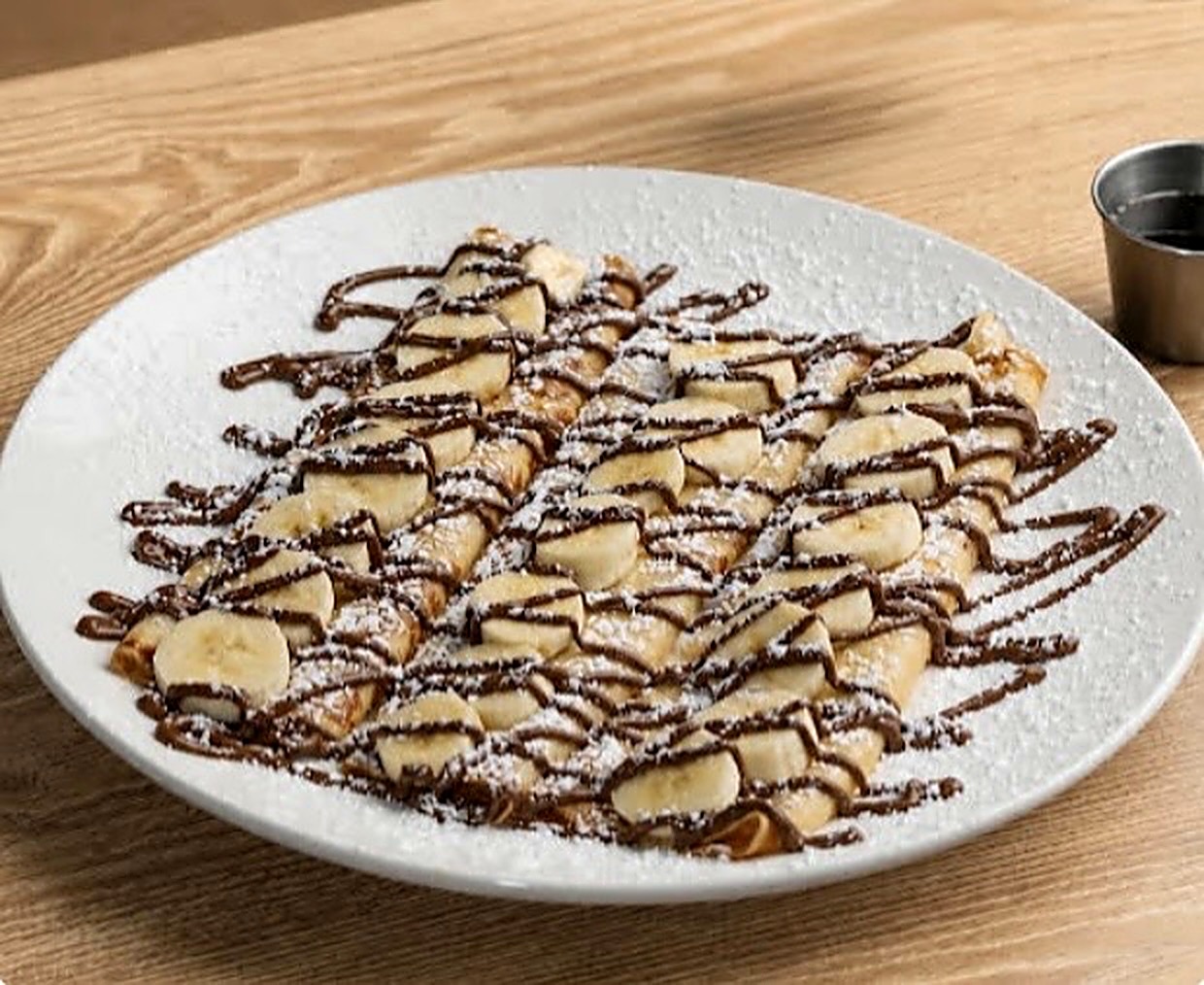 Nutella crepes with banana slices and powdered sugar
