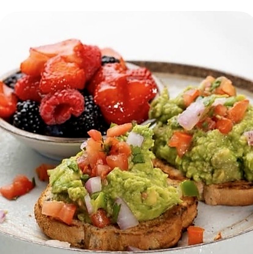 Avocado toast with pico de gallo and a bowl of fresh berries